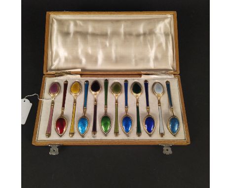 A set of twelve multi-coloured enamelled silver demitasse spoons, 84 marked, (some damage to enamel)