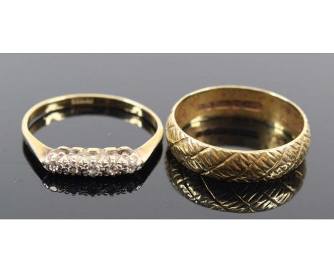 An 18ct carved gold wedding band, size N/O; together with an 18ct gold half-hoop ring set with five small round cut diamonds,