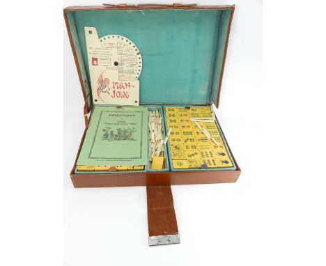 A Chad Valley mah-jong set in leather case, with instructions144 image tiles, and 4 blank