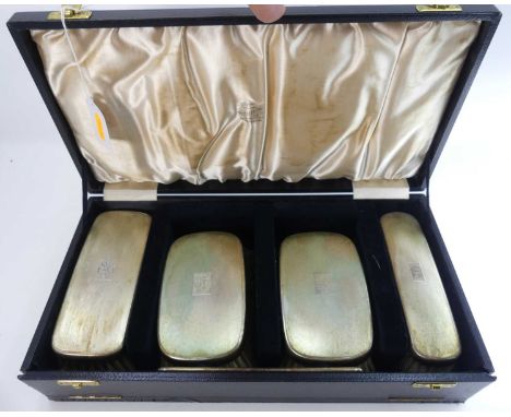 A set of four George VI silver-backed clothes brushes, each with engine turned decoration, two with family crest and one with