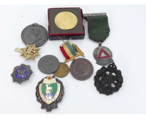 An early 20th century silver and enamelled brooch for the Army Service Corps, together with an RAF economy cap badge, a Queen