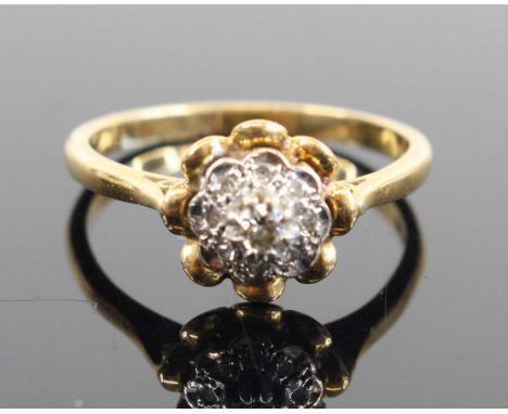 An 18ct gold diamond point set flower head cluster ring, size P, 3.4g