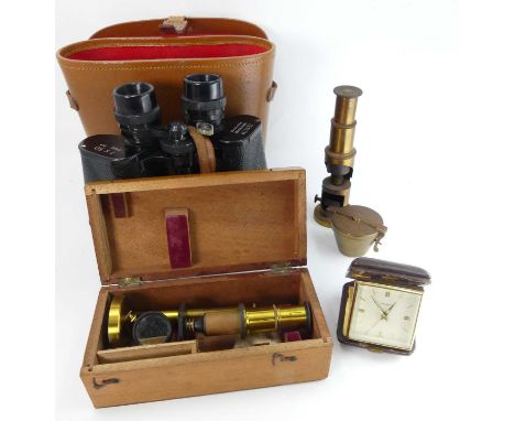 An early 20th century lacquered brass monocular student's microscope, in mahogany case; together with one other loose example