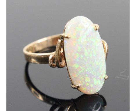 A yellow metal opal dress ring, the four-claw set cabochon opal measuring approxk 20 x 9.5 x 3mm, setting and band unmarked b