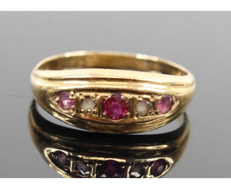 A vintage yellow metal ruby and rose cut diamond set half-hoop ring, unmarked but tests as approx 18ct gold, size N, 2.7gSlig