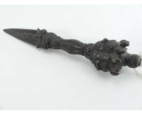 A Tibetan cast iron ritual(?) dagger, having a triform blade, the terminal embossed with four faces, length 22cmNo chips, spl