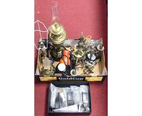 A collection of lighting, to include an ornate cast metal figural table lamp, early 20th century brass oil lamp; and a set of