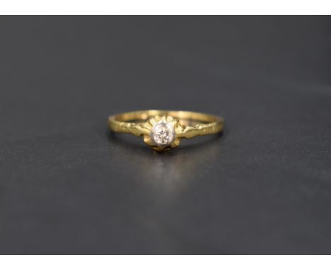 A diamond solitaire ring, the diamond set in a bezel illusion setting on a 18ct gold shank, ring size M and approx 2.1g