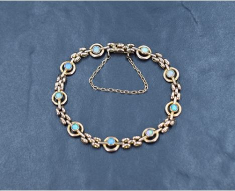 A Victorian 9ct rose gold bracelet having collet set opals in circular links with gold brick effect interlinks and a conceale