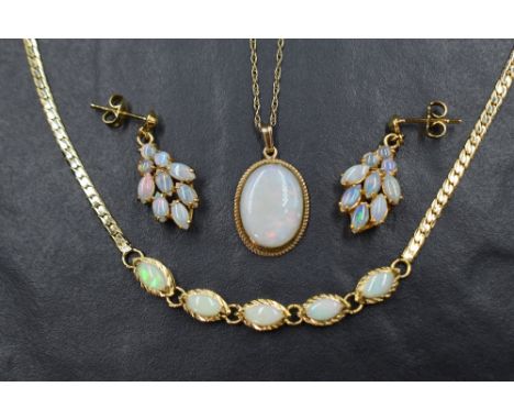 An Oval opal pendant in a 9ct gold collared mount on a 9ct gold chain, approx 18' &amp; 2.7g with a matched five opal gold pl