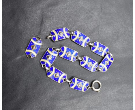 A Scandinavian silver and enamel ten panel bracelet, (one panel loose) having blue and cream decoartion with silver link conn