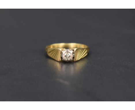 A diamond solitaire ring, the diamond set in an illusion setting with graduated line engraved shoulders, on an 18ct gold shan