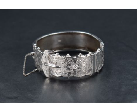 A Victorian silver hinged bangle in the form of a buckled belt, internal diameter 55mm x 48mm, approx 23.3g