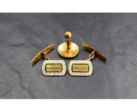 A pair of yellow metal and enamel cufflinks stamped 22C having green and white detail to front panel with chain connectors, a