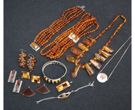 A selection of modern Baltic Amber jewellery including silver pendants, bangle, multi bead necklace and bracelet, rough cut n