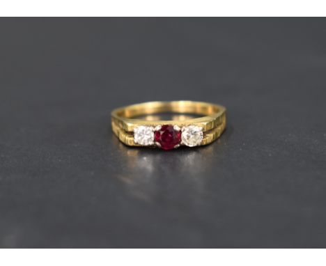 A diamond and ruby trilogy ring having three equal stones, each approx 0.128ct in a claw set mount to architectural style ope