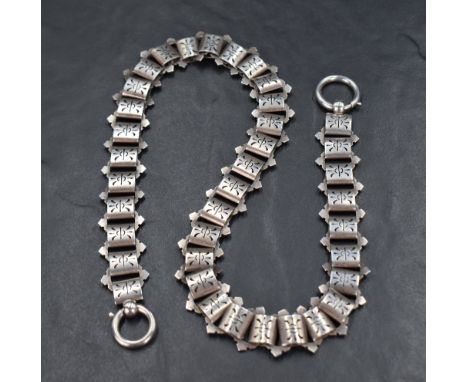 A Victorian white metal chain having pierced brick links and a double clasp, approx 18' &amp; 39.7g
Condition report: Chain i