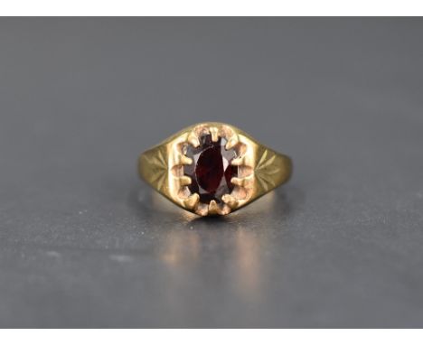 A gent's 9ct gold signet ring having a gypsy set oval garnet, size S &amp; 5.8g