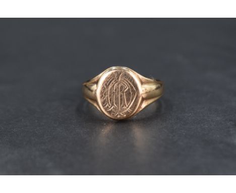 A 9ct gold signet ring, having a monogram engraved to the oval face with tapering shoulders, ring size U and approx 7.1g