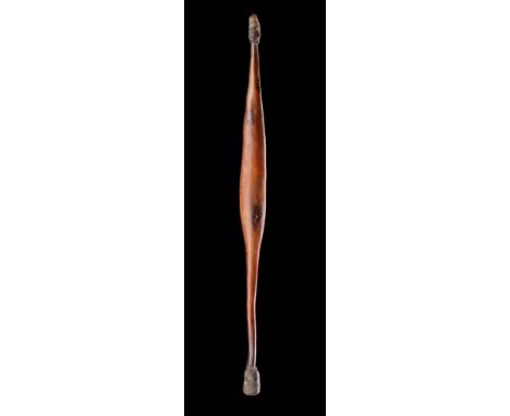 AN ABORIGINAL SPEAR THROWER  AUSTRALIA, 19TH CENTURY  Wood, gum, tooth or claw, modern stand  thrower 63cm long  Together wit