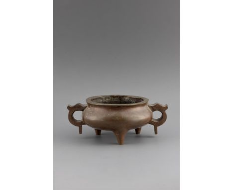 A CHINESE BRONZE TWIN HANDLED CENSER  17TH/18TH CENTURY  The base cast with a four-character xuande mark  23.5cm wide   Condi