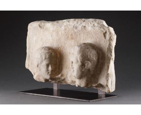 A HELLENISTIC MARBLE FUNERARY STELE IN HIGH RELIEF  CIRCA 2ND CENTURY BC  With two male heads, modern stand  stele 20.5cm hig