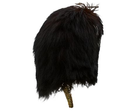 AN OFFICER'S BEARSKIN, of characteristic form, the wicker and cane body with black fur outer, leather backed brass chin chain