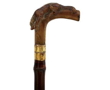 A CONTINENTAL SWORD STICK, the horn handle carved as a resting hound, 34cm flattened diamond section tapering blade, wooden h