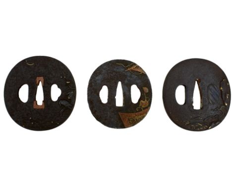 THREE CIRCULAR IRON TSUBA, the first chiselled with a landscape, soft metal details, the second with a bird perched on a bran