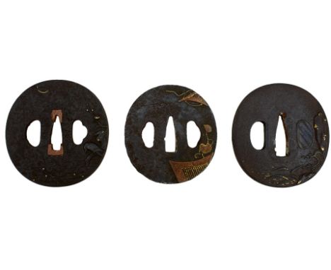 THREE CIRCULAR IRON TSUBA, the first chiselled with a landscape, soft metal details, the second with a bird perched on a bran