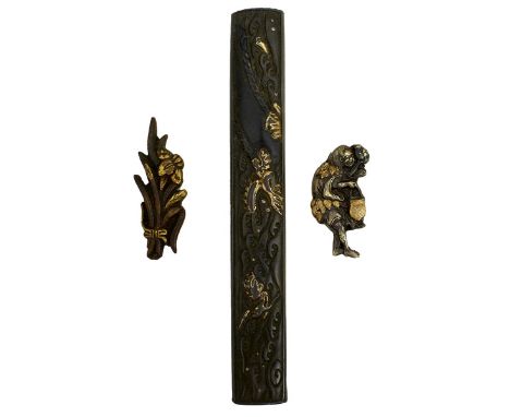 A KODZUKA AND TWO PAIRS OF MENUKI, the first of shibuichi decorated with a dragon amidst crashing waves, soft metal details, 