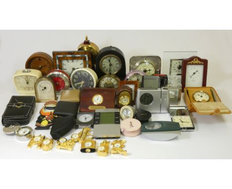 A collection of mantle clocks to include a Kundo anniversary example, a bracket style manual wind mantle clock and various tr