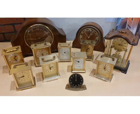 A collection of mantle and carriage clocks including an Enfield Bakelite mantle clock and a brass 8 day carriage type clock w