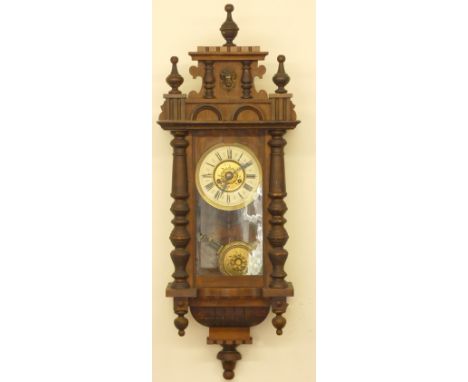 A Vienna style 8 day wall clock, spring driven pendulum movement, housed in a mahogany case with turned finial and side colum