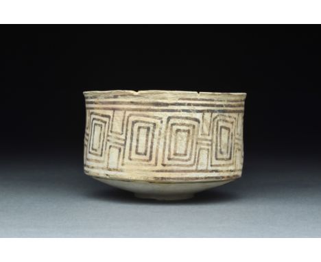 Ca. 2700-2400 BCA pottery cup with a petite circular foot, a broad base, tall walls, and a slightly flared rim surrounding th