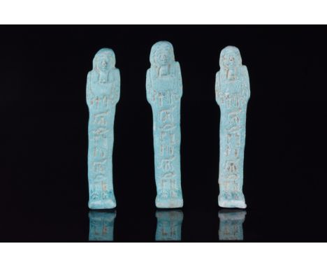 Ca. 664–332 BCA group of three pale blue-glazed faience shabti figures in mummiform pose. Wearing a lappet wig and false bear
