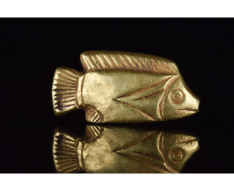 New Kingdom, Ca. 1550-1069 BCA golden amulet in the shape of a tilapia fish. A cast gold amuletic bead with a suspension hole