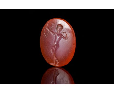 Ca. 400 BCA carnelian oval-shaped intaglio engraved with a youthful naked male archer with arm outstretched with bow, other h