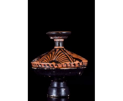 Ca. 340-325 BCA ceramic lekanis of the red-figure lid with two female profile heads between palmettes and stylised volutes. T