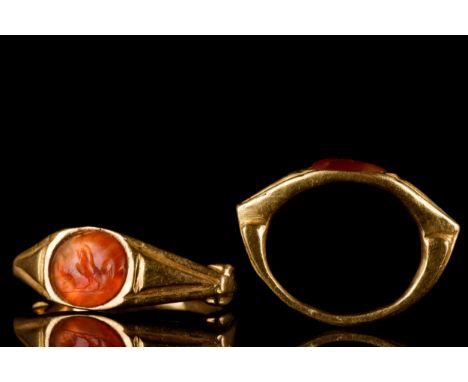 Ca. 100-300 ADA stunning gold finger ring of a grooved hoop flaring to decorated, angled shoulders supporting an oval bezel s