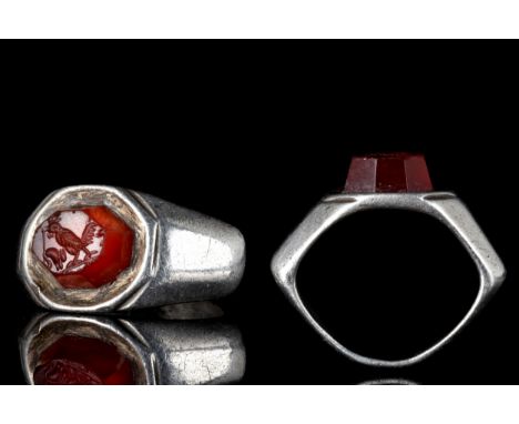 Ca. 100-200 ADA beautifully formed finger ring with faceted, expanded shoulders supporting a carnelian stone intaglio finely 