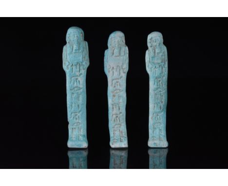 Late Dynastic Period, Ca. 664-332 BCA set of three finely modelled blue-glazed faience shabti figures in mummiform pose. Wear