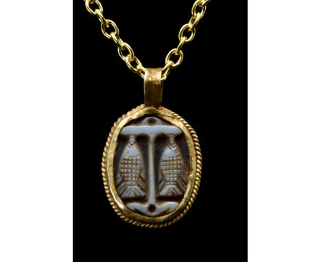 Ca. 300-400 ADA finely carved sardonyx cameo decorated with the emblem of an anchor flanked by two suspended fishes. The symb