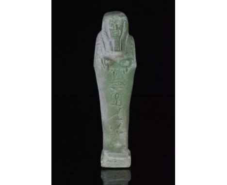 Ca. 664-525 BCAn ancient Egyptian glazed faience shabti figure in mummiform pose; the figure is well modelled with a triparti