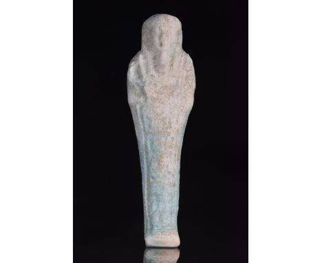 Late Dynastic Period, Ca. 664-332 BC A pale turquoise faience Egyptian shabti modelled with a tripartite wig and false beard.