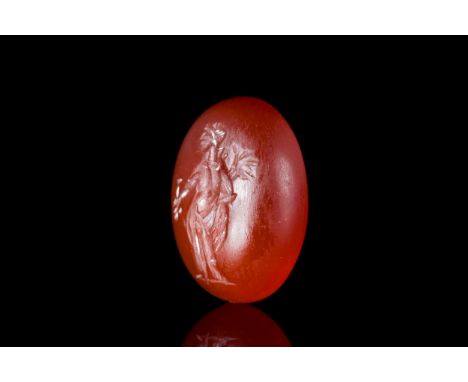 Ca. 200-300 ADAn oval-shaped carnelian intaglio, engraved with goddess Fortuna holding a cornucopia and rudder. For comparabl
