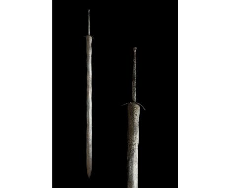 Ca. 350-300 BCSword with only a slight boss for a pommel and a highly curved, short cross guard. The tang is very long, this 
