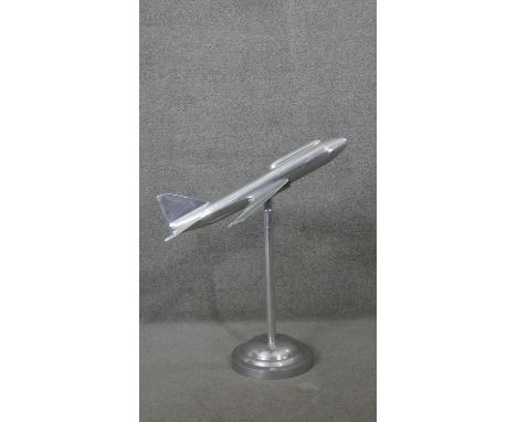 A large chrome model of a vintage style passenger jet on circular stand. H.78 W.68 D.68cm 