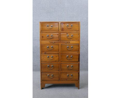 A Chinese hardwood chest of drawers fitted with central slide on shaped bracket feet. H.104 W.60 D.45CM 