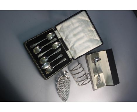 A collection of silver and silver plate. Including a cased set of silver coffee spoons, a silver toast rack, cake server and 